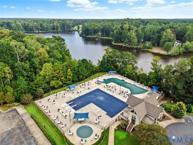 an aerial view of a house with garden space and lake view