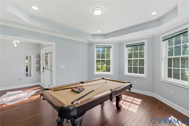 a room with furniture pool table and windows
