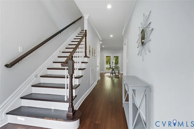 a view of entryway and hall with wooden floor