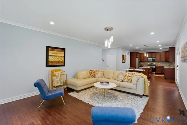 a living room with furniture and a wooden floor