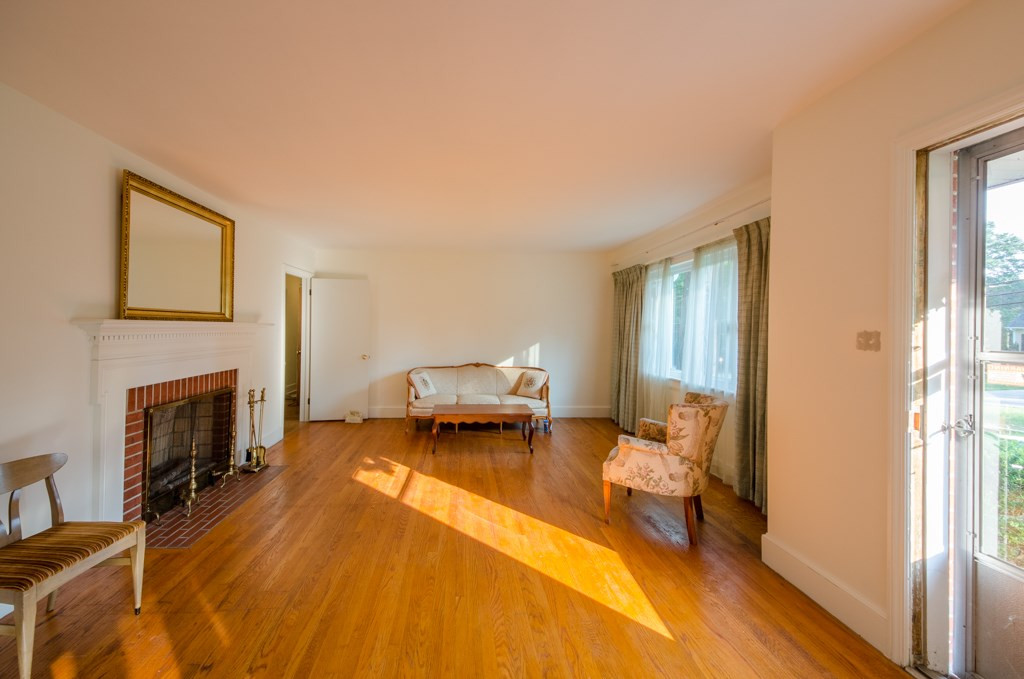 401 West Cornwallis Road Durham, NC 27707 - Photo 7 of 10 Living room has fireplace and hardwood floors. Living Room