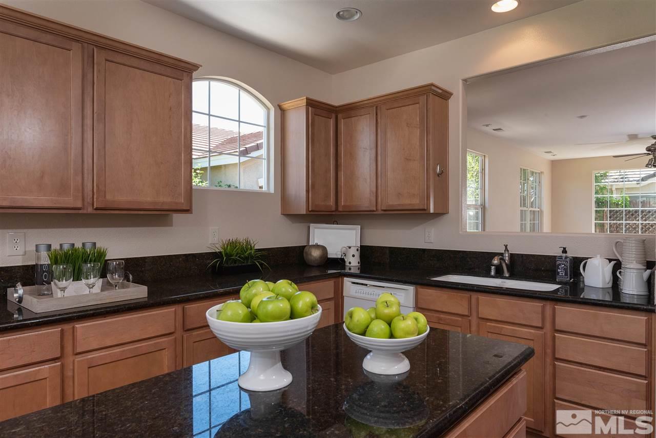 1614 Mountain Lane Reno, NV 89521 - Photo 1 of 25 a kitchen with a sink a stove cabinets and a window