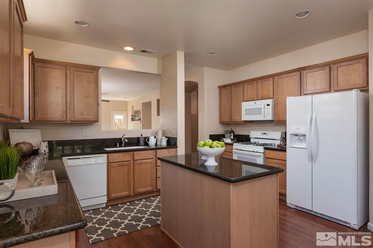 1614 Mountain Lane Reno, NV 89521 - Photo 5 of 25 a kitchen with stainless steel appliances granite countertop a refrigerator stove microwave and sink