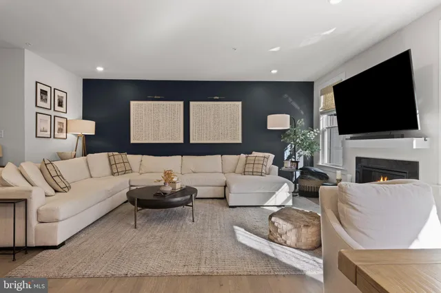 a living room with fireplace furniture and a flat screen tv