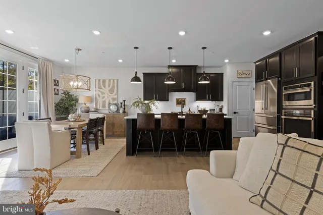 a living room with lots of furniture and kitchen view