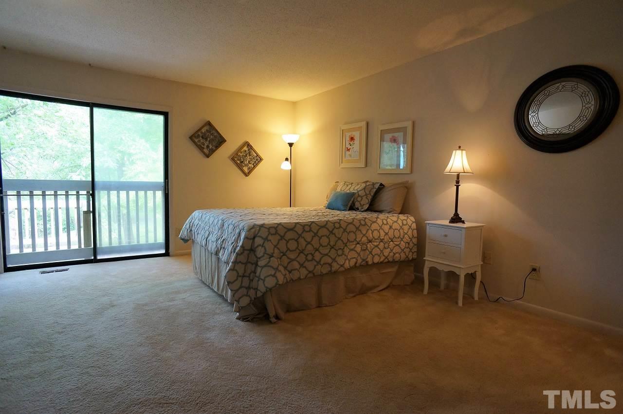 5803 Mapleridge Road Raleigh, NC 27609 - Photo 12 of 23 a bedroom with a bed and a large window