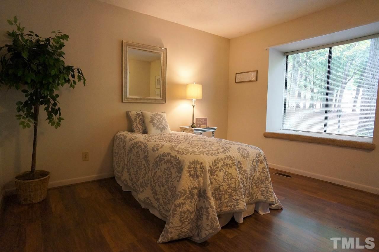 5803 Mapleridge Road Raleigh, NC 27609 - Photo 13 of 23 a bedroom with a bed and a potted plant