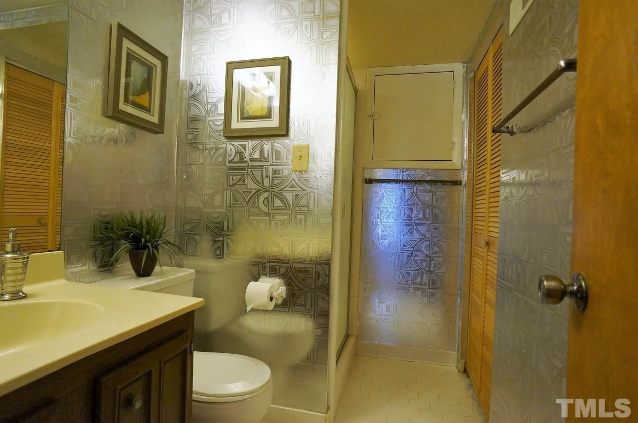 5803 Mapleridge Road Raleigh, NC 27609 - Photo 19 of 23 a bathroom with a sink a toilet and shower