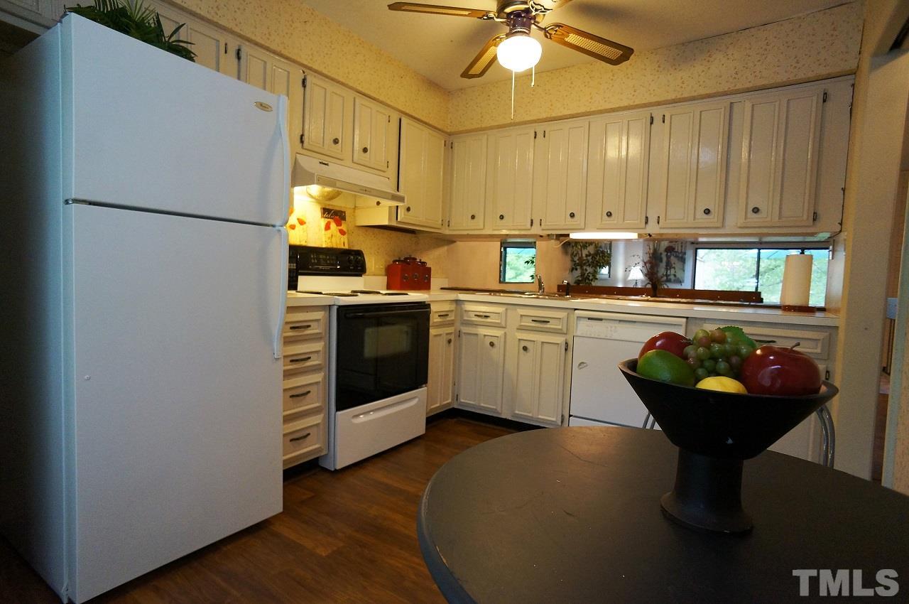 5803 Mapleridge Road Raleigh, NC 27609 - Photo 3 of 23 a kitchen with stainless steel appliances granite countertop a sink a stove and refrigerator