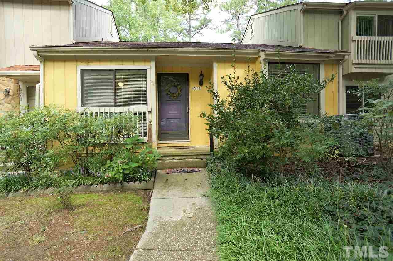 5803 Mapleridge Road Raleigh, NC 27609 - Photo 23 of 23 a view of a house with potted plants and a table and chairs