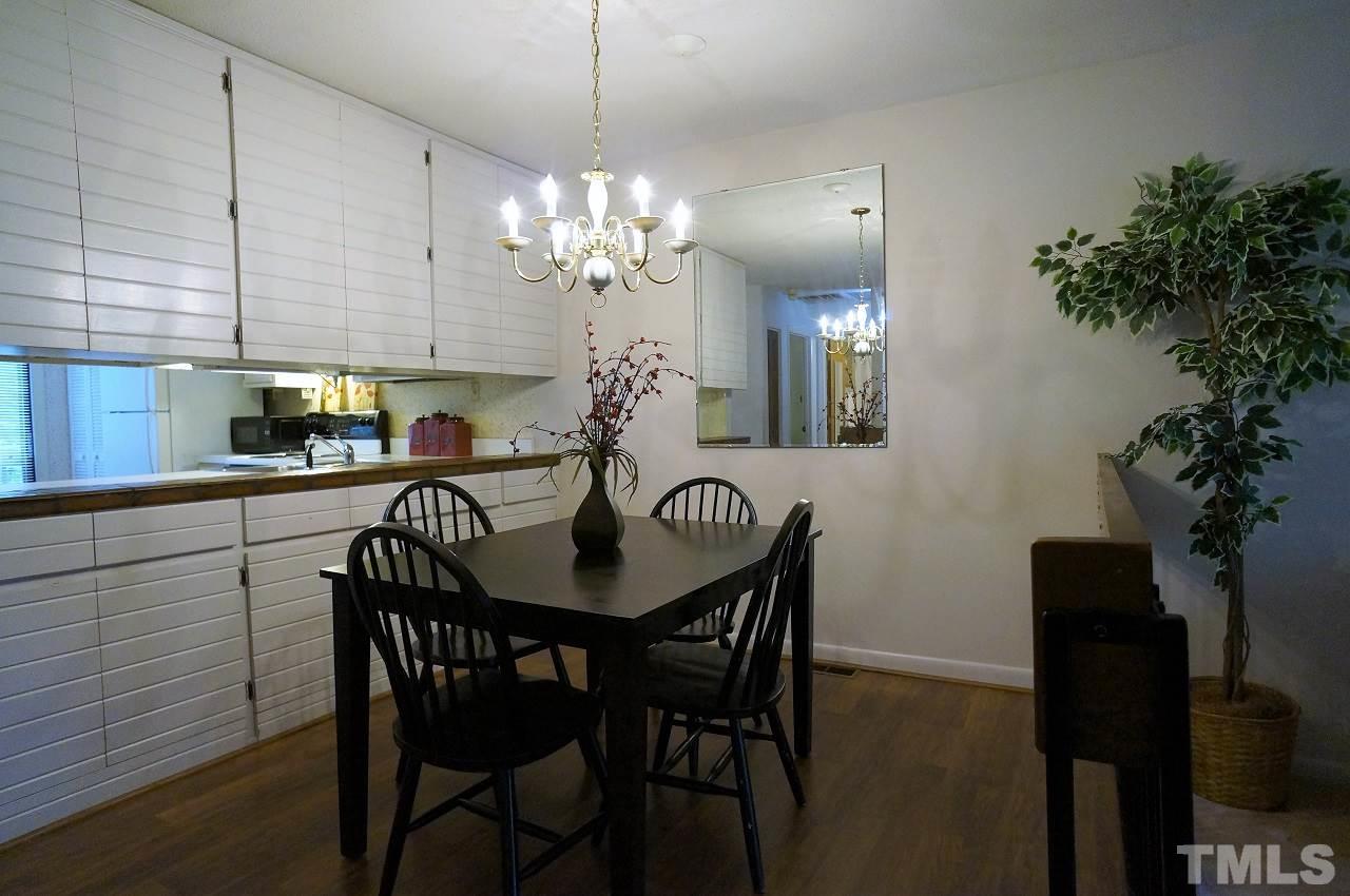 5803 Mapleridge Road Raleigh, NC 27609 - Photo 4 of 23 a view of a dining room with furniture and chandelier