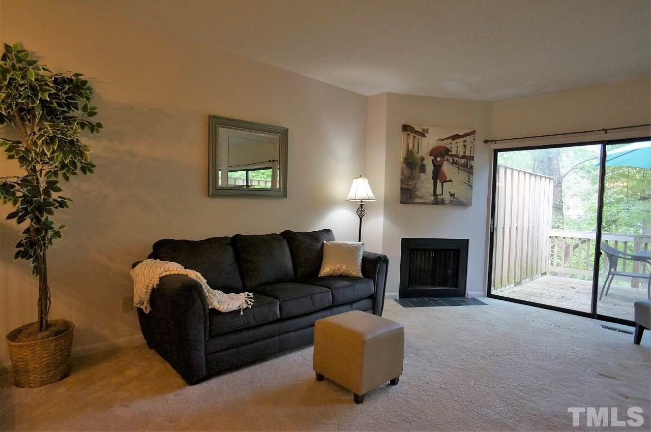 5803 Mapleridge Road Raleigh, NC 27609 - Photo 6 of 23 a living room with furniture and a fireplace