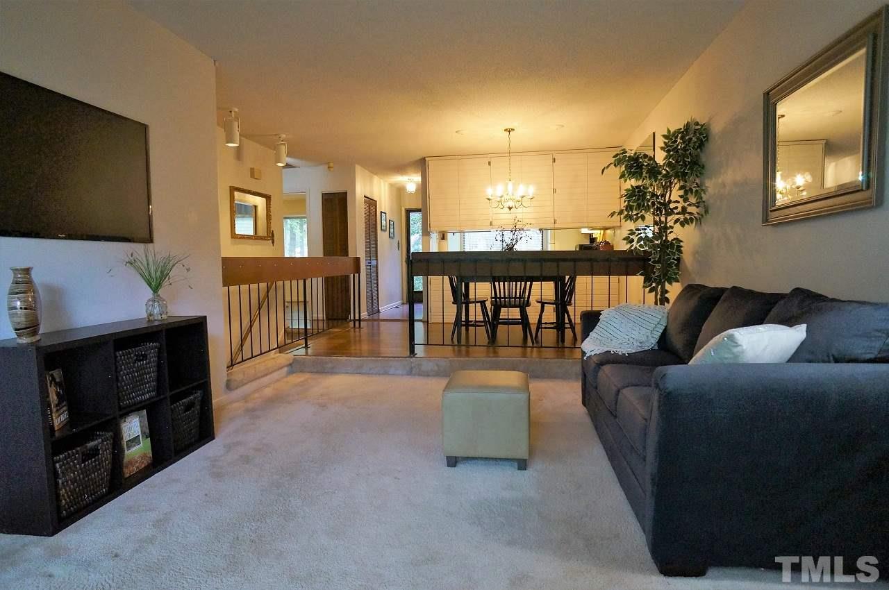 5803 Mapleridge Road Raleigh, NC 27609 - Photo 9 of 23 a living room with furniture and a flat screen tv
