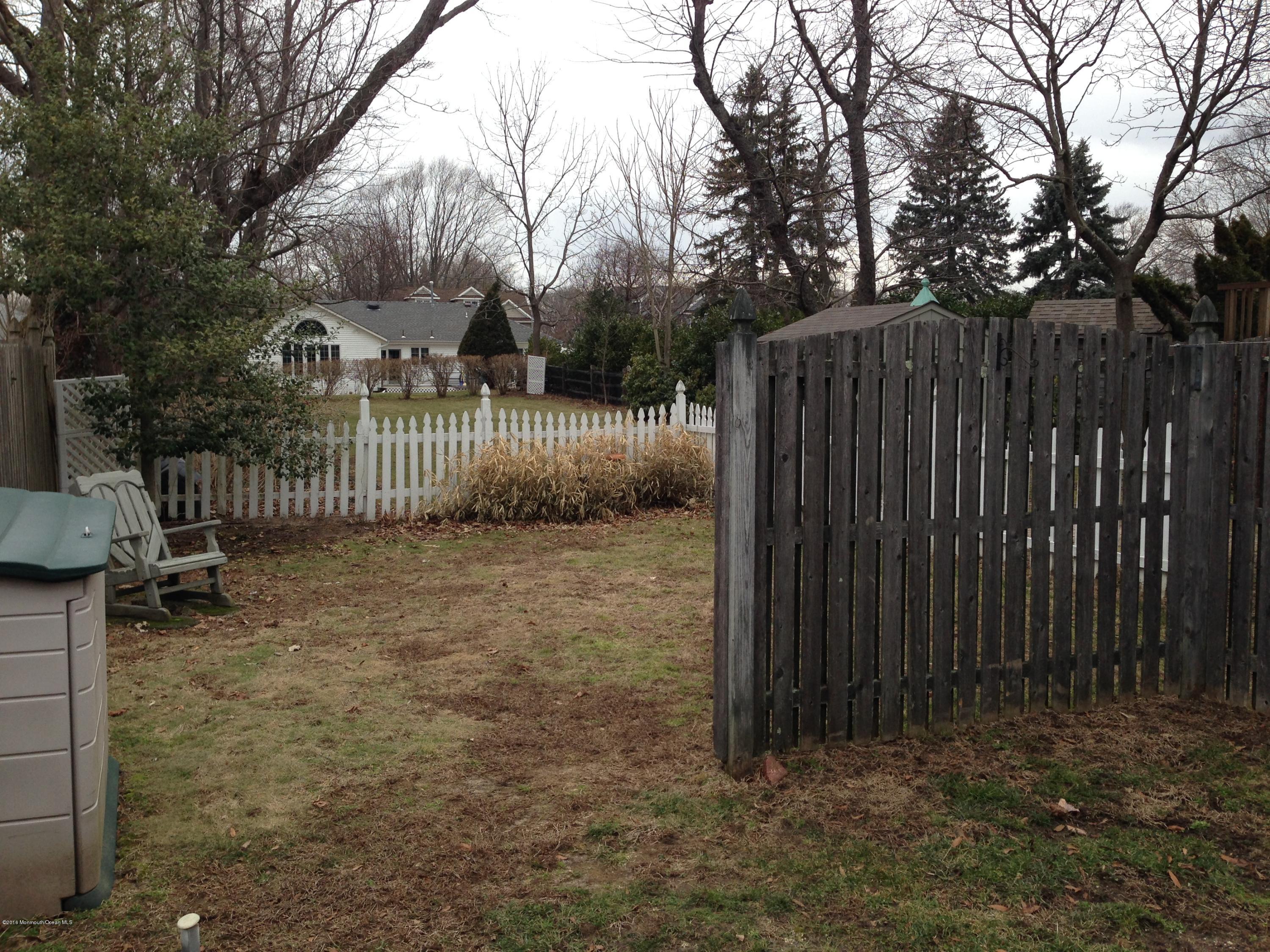 115 10th Avenue Spring Lake Heights, NJ 07762 - Photo 12 of 15 a view of backyard with wooden fence and trees