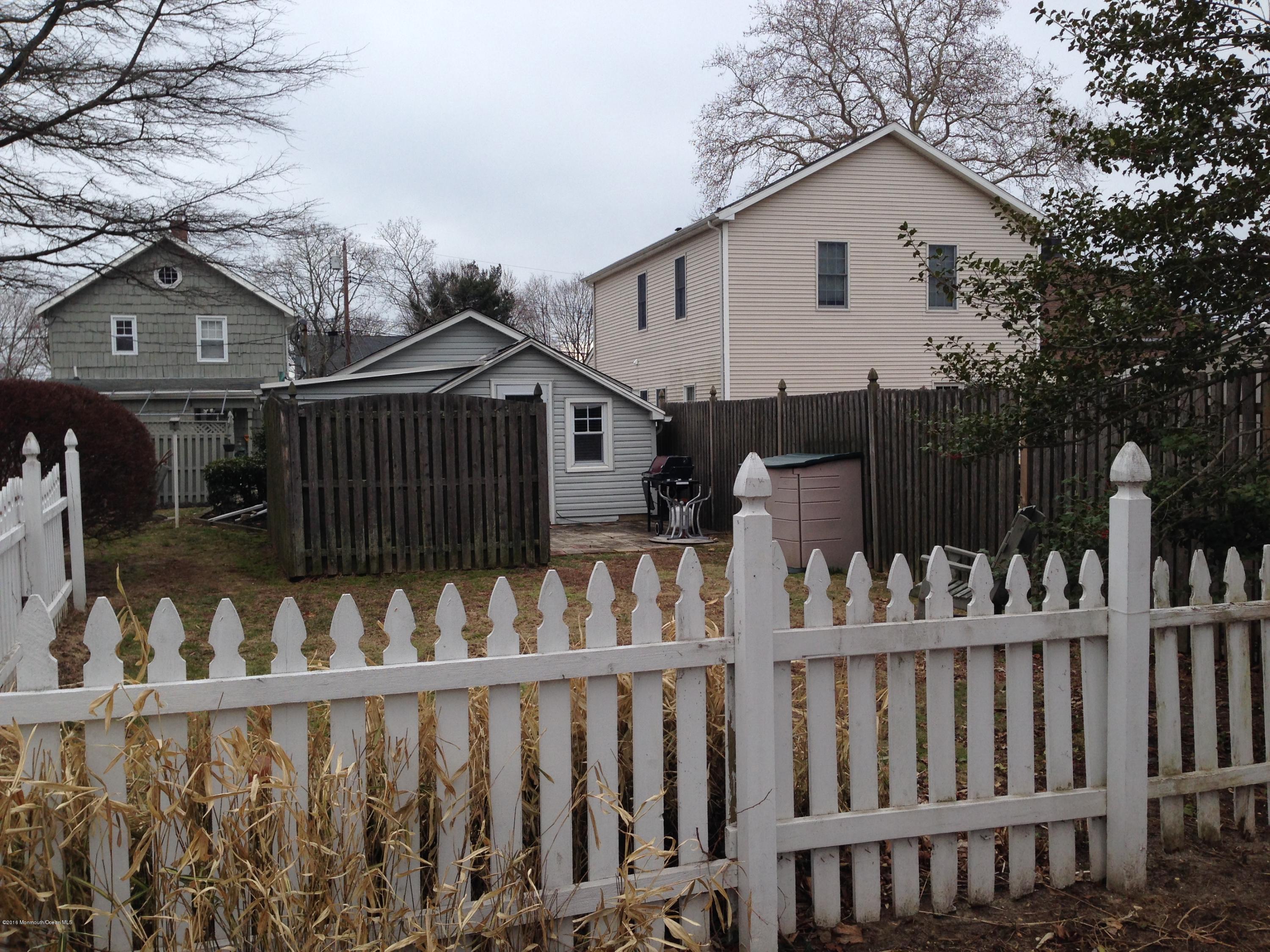 115 10th Avenue Spring Lake Heights, NJ 07762 - Photo 13 of 15 a view of a wooden house with a small yard