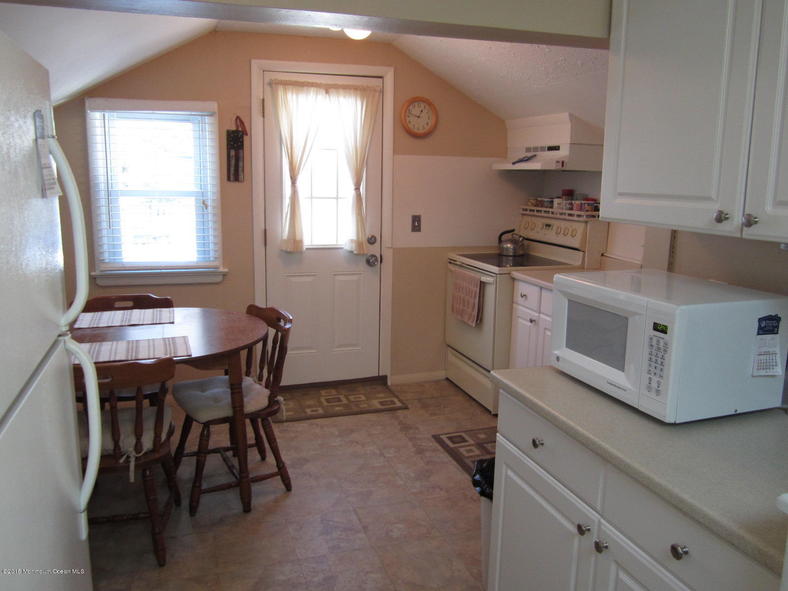 115 10th Avenue Spring Lake Heights, NJ 07762 - Photo 4 of 15 a kitchen with stainless steel appliances kitchen island a table chairs in it and a window