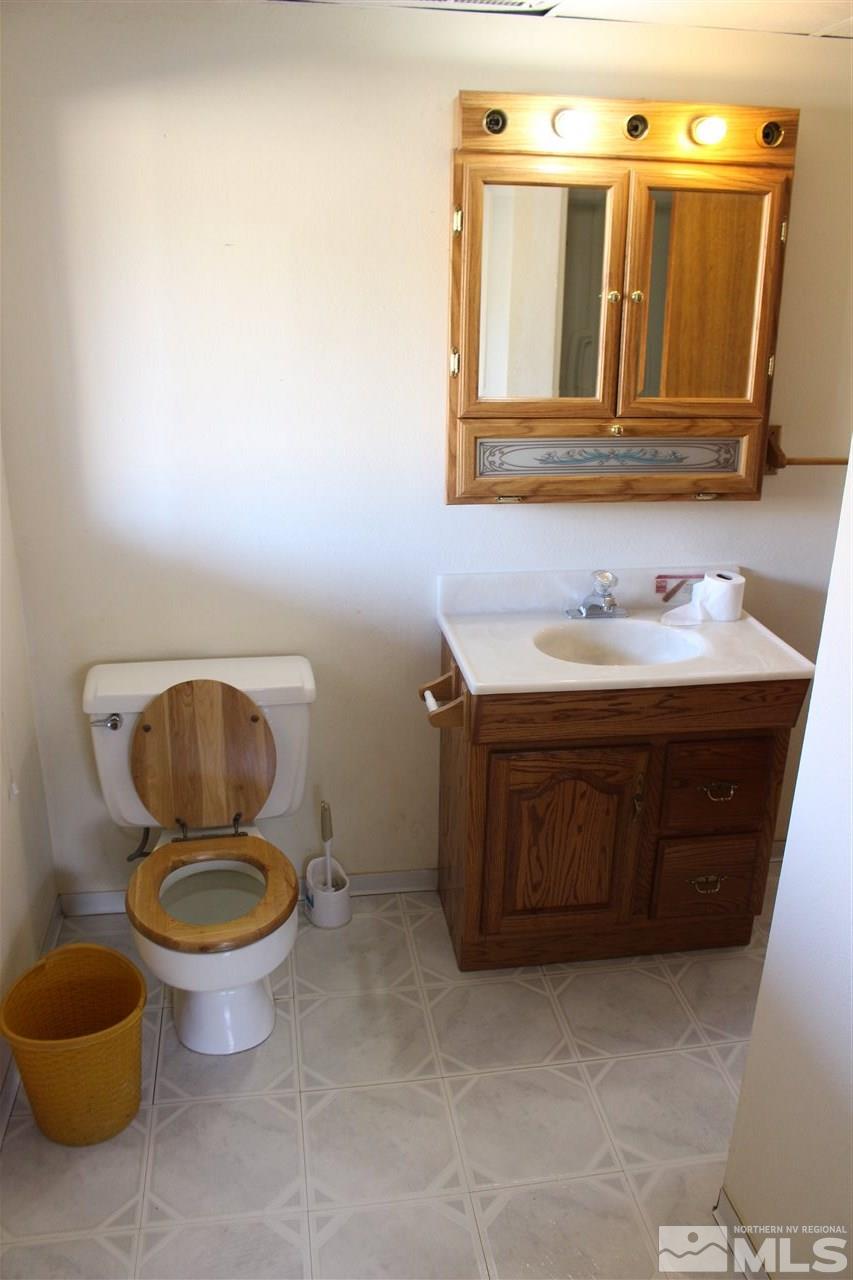 14580 Seminole Trail Reno, NV 89521 - Photo 8 of 21 a bathroom with a toilet a sink and mirror