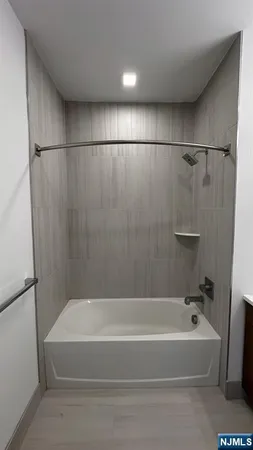 a bathroom with a bathtub and a shower