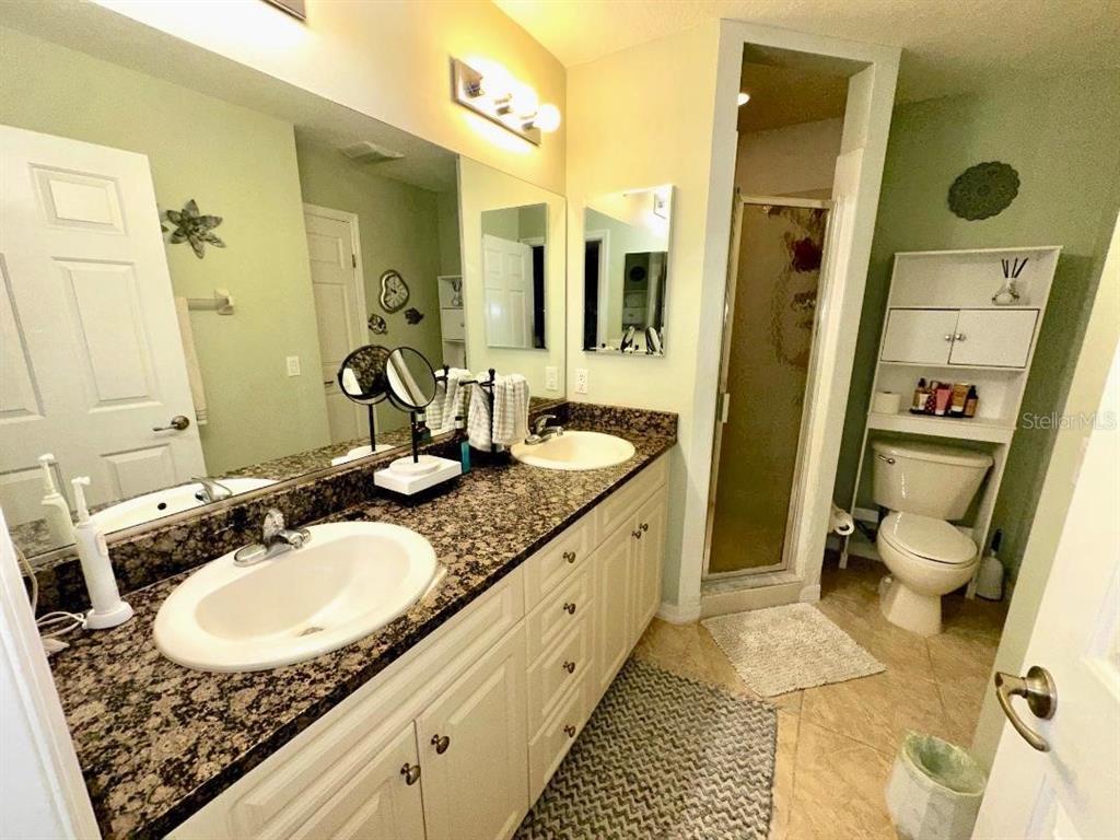 891 East Rembrandt Way Inverness, FL 34453 - Photo 13 of 27 a bathroom with a granite countertop sink and a mirror