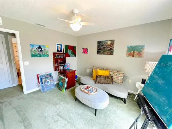 a living room with baby toys and furniture