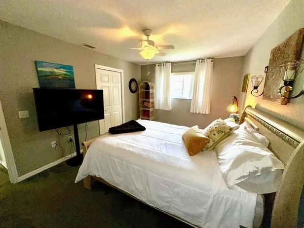 a bedroom with a bed and a television