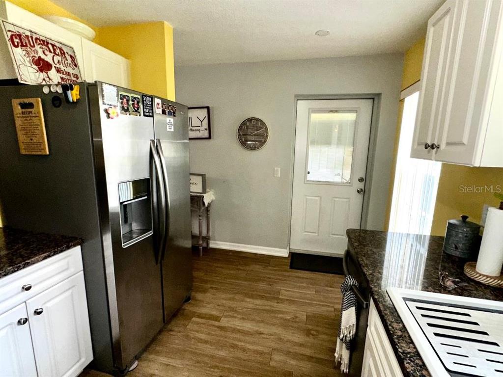 891 East Rembrandt Way Inverness, FL 34453 - Photo 23 of 27 a view of a kitchen with refrigerator and wooden floor