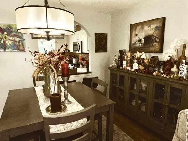 a view of a dining room with furniture and chandelier