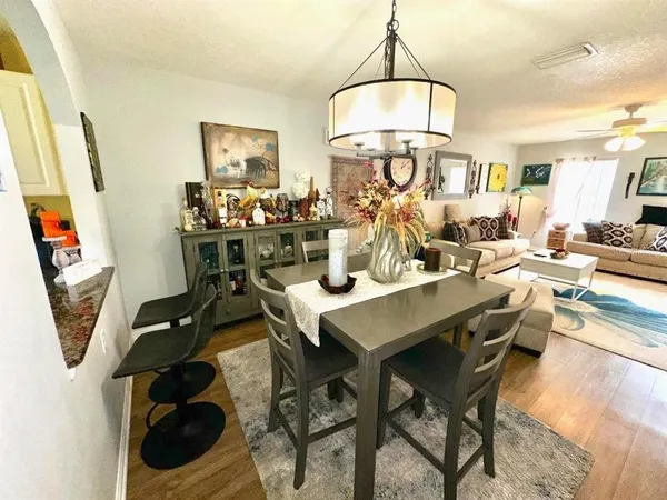 a view of a dining room with furniture and a chandelier