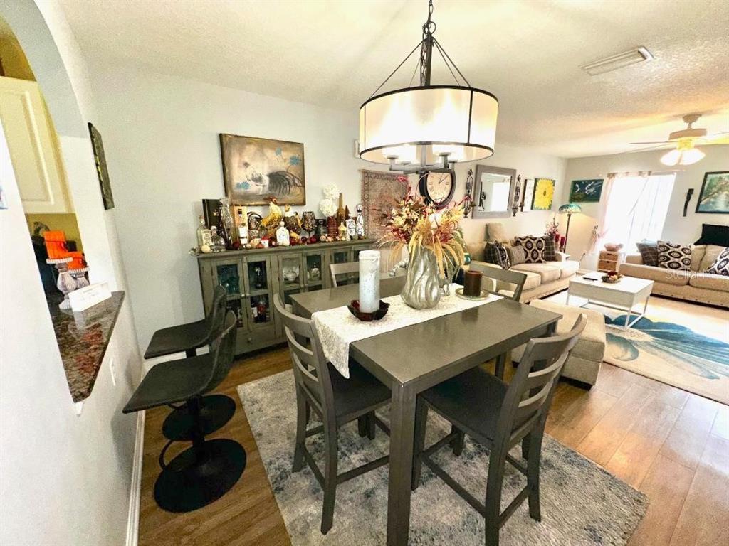 891 East Rembrandt Way Inverness, FL 34453 - Photo 5 of 27 a view of a dining room with furniture and a chandelier