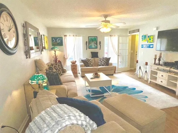 a living room with furniture a fireplace and a large mirror
