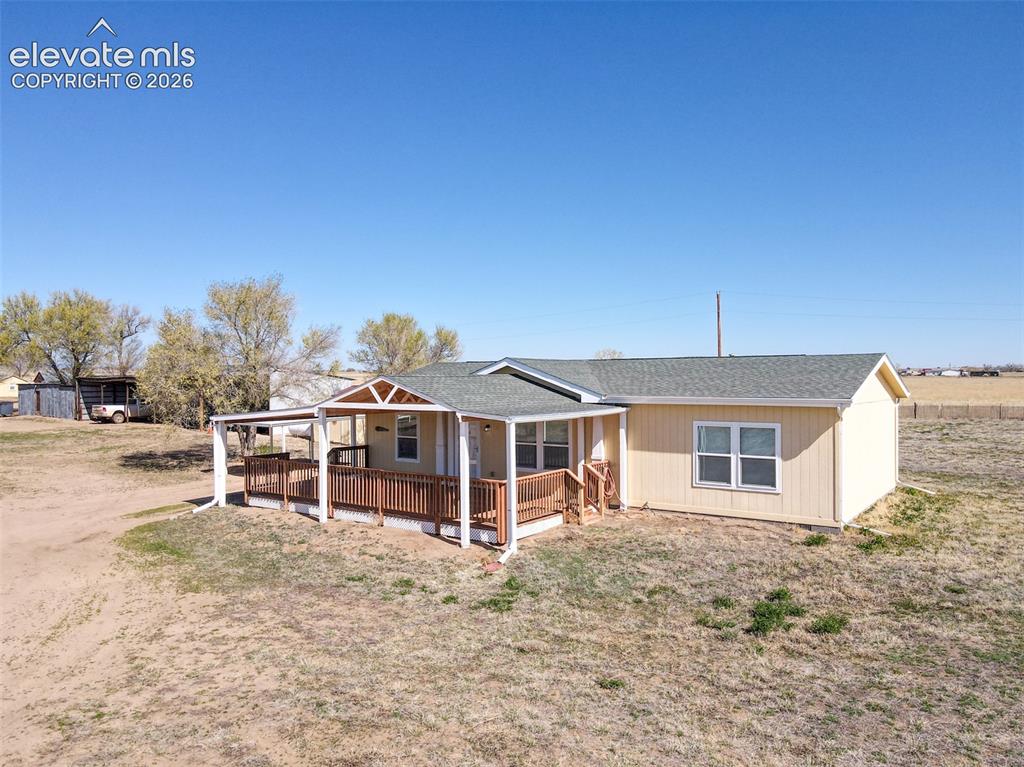 22558 Enoch Road Calhan, CO 80808 - Photo 3 of 50 a view of a house with a yard and sitting area