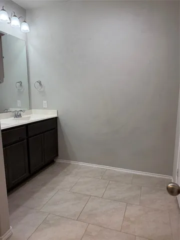 a bathroom with a sink vanity and mirror