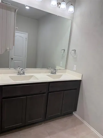 a bathroom with a sink vanity and mirror