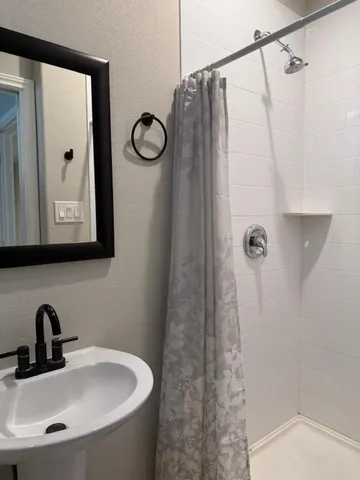 a bathroom with a sink and mirror
