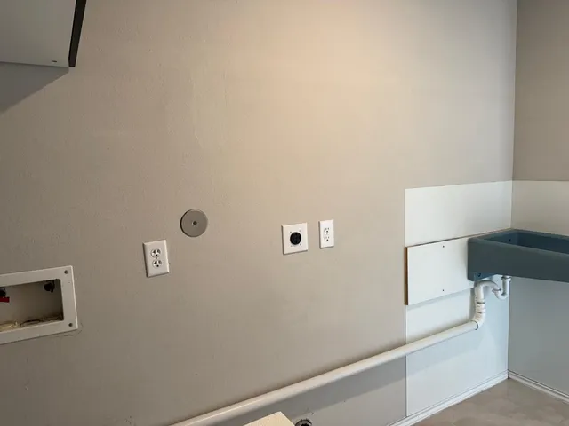 a large kitchen with stainless steel appliances granite countertop a refrigerator and a stove