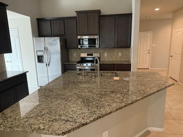 a view of a kitchen with a sink and a microwave