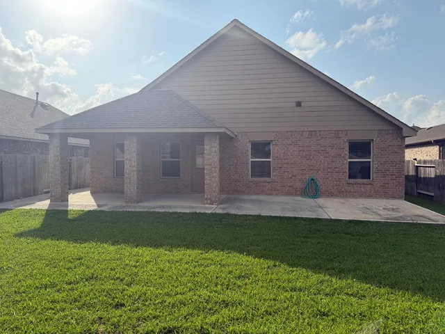 a view of a house with backyard and porch