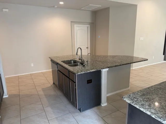 a kitchen with a stove top oven and cabinets