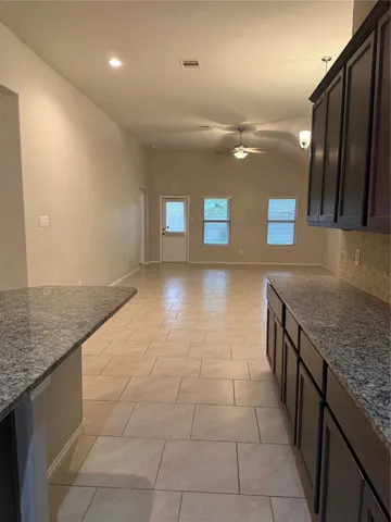 a kitchen with stainless steel appliances granite countertop a sink and a stove