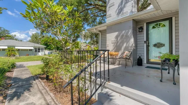front view of house with a chairs and table in the patio