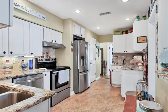 a kitchen with stainless steel appliances a refrigerator sink and cabinets