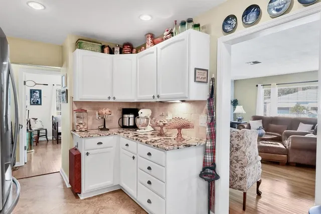 a kitchen with white cabinets and appliances