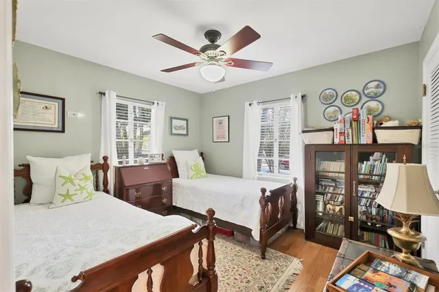 a bedroom with furniture and a large window