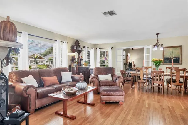a living room with furniture dining table and a large window