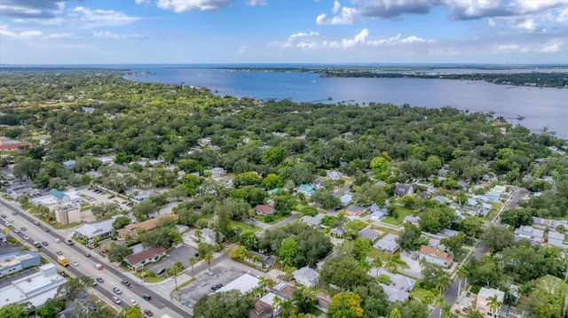 an aerial view of a houses with a yard