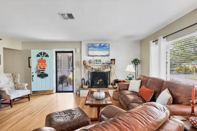 a living room with furniture large window and a fireplace