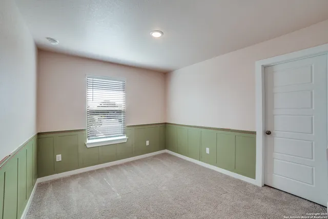 an empty room with closet and windows