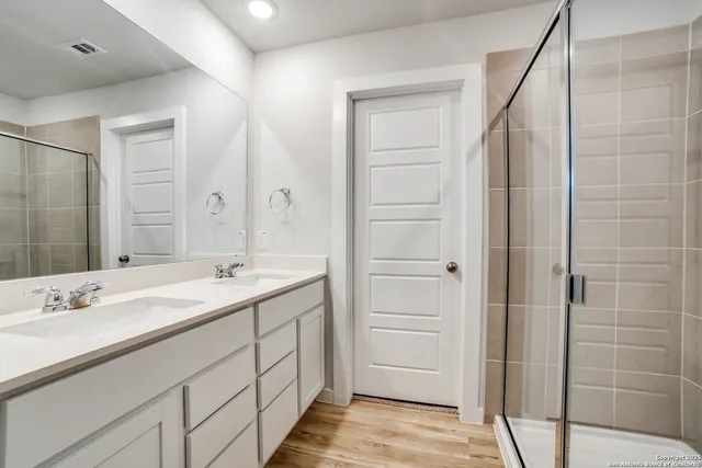 a bathroom with a double vanity sink and mirror