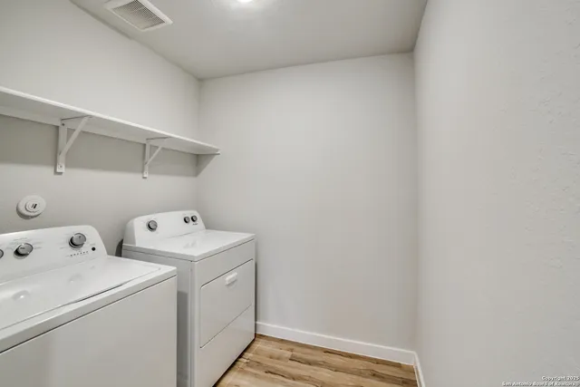 a view of storage and utility room with washer and dryer