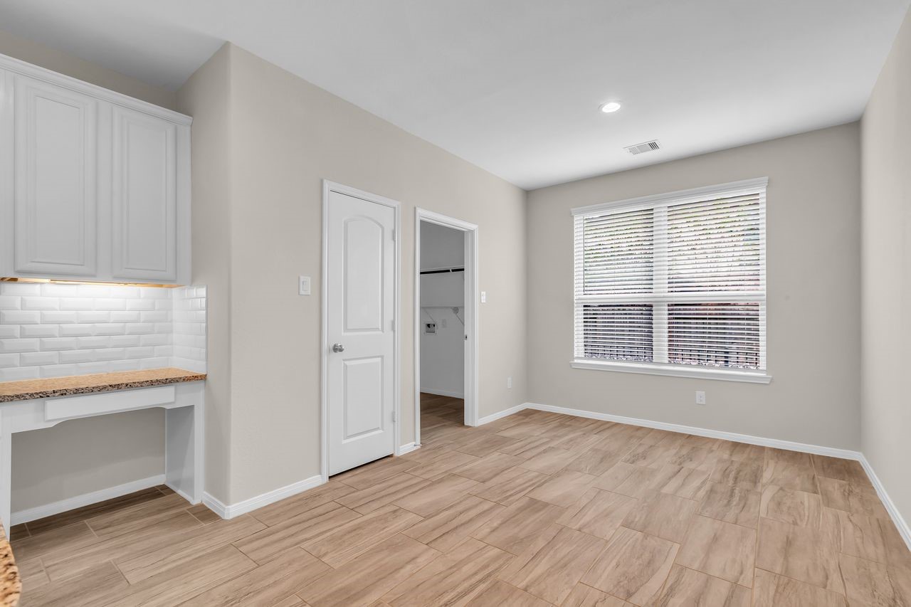 14304 Prospect Park Lane Conroe, TX 77384 - Photo 11 of 38 a view of an empty room with wooden floor and a window
